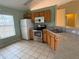 Galley kitchen with stainless steel appliances and wood cabinets at 28 Juniper Loop Ter, Ocala, FL 34480