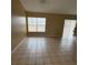 Large living room featuring tile flooring and a ceiling fan at 28 Juniper Loop Ter, Ocala, FL 34480