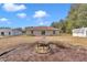 Backyard view showing patio, fire pit, and surrounding land at 3 Locust Trak, Ocala, FL 34472