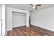 Bedroom with wood-look floors, ceiling fan, and closet at 3 Locust Trak, Ocala, FL 34472