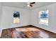 Bright bedroom with wood-look flooring, two windows and ceiling fan at 3 Locust Trak, Ocala, FL 34472