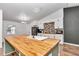 Modern kitchen with butcher block island, white cabinets, and brick backsplash at 3 Locust Trak, Ocala, FL 34472