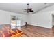 Living area with wood-look floors, sliding glass doors and a ceiling fan at 3 Locust Trak, Ocala, FL 34472