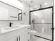 Modern bathroom with frameless glass shower and quartz countertop at 3690 Se 133Rd Pl, Belleview, FL 34420