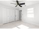 Spacious bedroom with double doors leading to a large closet and marble-look tile floors at 3690 Se 133Rd Pl, Belleview, FL 34420