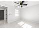 Bright bedroom with ceiling fan and marble-look tile flooring at 3690 Se 133Rd Pl, Belleview, FL 34420