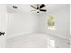 Bright bedroom with ceiling fan and marble-look tile flooring at 3690 Se 133Rd Pl, Belleview, FL 34420