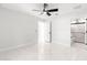 Bedroom with marble flooring, a ceiling fan and an ensuite bathroom at 3690 Se 133Rd Pl, Belleview, FL 34420