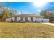 One-story home with gray trim and a white exterior at 3690 Se 133Rd Pl, Belleview, FL 34420