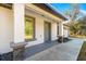 Front porch with gray door and stone accents at 3690 Se 133Rd Pl, Belleview, FL 34420