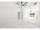 Spacious living room with high ceilings, tile floors, and a ceiling fan at 3690 Se 133Rd Pl, Belleview, FL 34420