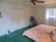 Bright bedroom with king-size bed, double doors, and green carpet at 4172 Ne 35Th Avenue Rd, Ocala, FL 34479