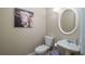 Powder room with a pedestal sink, toilet, and decorative cow art at 4343 Nw 80Th Ave # 8, Ocala, FL 34482