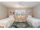 Bedroom with twin beds, window shutters, and stylish area rug at 4343 Nw 80Th Ave # 8, Ocala, FL 34482