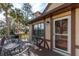 Inviting deck area featuring brown wood, dark metal patio furniture, and an entrance to the home at 4343 Nw 80Th Ave # 8, Ocala, FL 34482