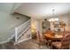 Dining area adjacent to the staircase features wood floors and a modern chandelier at 4343 Nw 80Th Ave # 8, Ocala, FL 34482