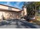 Exterior view of the home's side, showing the garage, a chimney, and an exterior deck area at 4343 Nw 80Th Ave # 8, Ocala, FL 34482