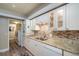 The kitchen showcases white cabinetry, stainless steel sink, and an adjacent laundry area at 4343 Nw 80Th Ave # 8, Ocala, FL 34482