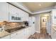 A well-lit kitchen featuring white cabinets, granite countertops, and modern appliances at 4343 Nw 80Th Ave # 8, Ocala, FL 34482