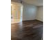 Living room with laminate flooring and access to bathroom at 571 Midway Trak # J103, Ocala, FL 34472