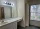 Functional bathroom featuring vanity, integrated lighting and a window at 5980 Se 4Th Pl, Ocala, FL 34472