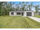 Newly built home featuring a gray garage door and white exterior at 6068 Nw 57Th Ave, Ocala, FL 34482