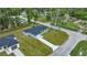 Aerial view of a new gray house with a grassy yard and driveway at 6088 Nw 57Th Ave, Ocala, FL 34482