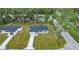 Aerial view showcasing a new gray house, neighboring home, and grassy lot at 6088 Nw 57Th Ave, Ocala, FL 34482