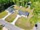Aerial view captures two single-story homes with fenced backyards, driveways, set amongst lush greenery and tall trees at 6088 Nw 57Th Ave, Ocala, FL 34482