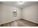 Simple bedroom with a window and wood-look floors at 6088 Nw 57Th Ave, Ocala, FL 34482