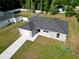 Beautiful single-story home featuring a gray exterior, dark roof, attached garage, and a well-manicured lawn at 6088 Nw 57Th Ave, Ocala, FL 34482
