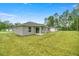 New home with gray exterior, covered patio, and grassy backyard at 6088 Nw 57Th Ave, Ocala, FL 34482