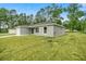 New construction home showcasing a gray exterior and a spacious yard at 6088 Nw 57Th Ave, Ocala, FL 34482