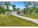 Gray house with a white garage door and a large grassy yard at 6088 Nw 57Th Ave, Ocala, FL 34482