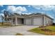 Gray two-car garage home with front porch at 6267 Sw 75Th Court Rd, Ocala, FL 34474