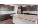 Kitchen island with granite countertop and dark cabinets at 6267 Sw 75Th Court Rd, Ocala, FL 34474