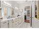 Double vanity bathroom with a view of a hallway and another room at 7267 Se 12Th Cir, Ocala, FL 34480