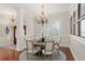 Formal dining room with round table, chandelier, and hardwood floors at 7267 Se 12Th Cir, Ocala, FL 34480