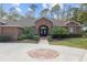 Brick home's front entrance, double doors and landscaping at 7267 Se 12Th Cir, Ocala, FL 34480