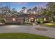 Brick home with circular driveway, illuminated at dusk at 7267 Se 12Th Cir, Ocala, FL 34480