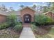 Brick entryway with double doors and landscape at 7267 Se 12Th Cir, Ocala, FL 34480