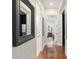 Bright hallway with hardwood floors and a view of a bedroom at 7267 Se 12Th Cir, Ocala, FL 34480