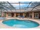 Relaxing kidney-shaped pool with screened enclosure at 7267 Se 12Th Cir, Ocala, FL 34480