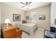 Bedroom with a queen-size bed, piano and ceiling fan at 7646 Sw 100Th Ct, Ocala, FL 34481