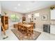 Rustic wooden dining table sits in a well-lit dining area at 7646 Sw 100Th Ct, Ocala, FL 34481