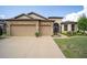 Two-story house with a three-car garage and landscaped lawn at 7646 Sw 100Th Ct, Ocala, FL 34481