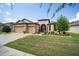 Two-story house with a three-car garage and landscaped lawn at 7646 Sw 100Th Ct, Ocala, FL 34481