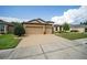 Two-story house with a three-car garage and nicely landscaped lawn at 7646 Sw 100Th Ct, Ocala, FL 34481