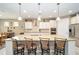 Kitchen island with seating, stainless steel appliances, and granite countertops at 7646 Sw 100Th Ct, Ocala, FL 34481