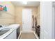 Laundry room with washer, dryer, and ample shelving at 7646 Sw 100Th Ct, Ocala, FL 34481